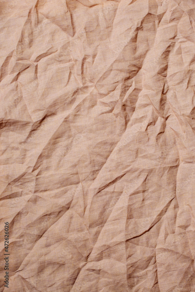 Fototapeta premium Top view on yellow wrinkled fabric. Background concept. 