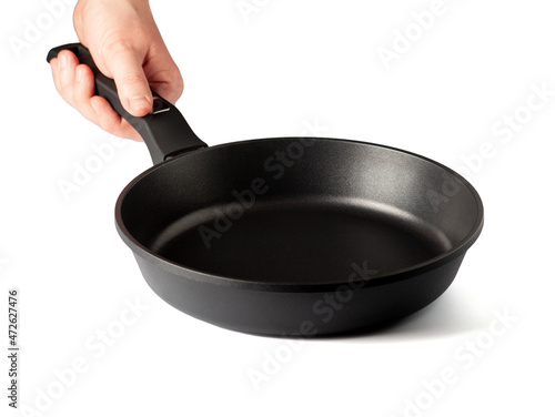 Fototapeta Male hand hold empty frying pan with non-stick coating isolated on white background
