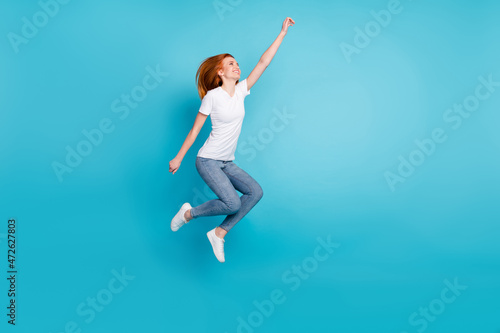 Fototapeta Naklejka Na Ścianę i Meble -  Full size profile side photo of young girl happy positive smile jump catch umbrella isolated over blue color background