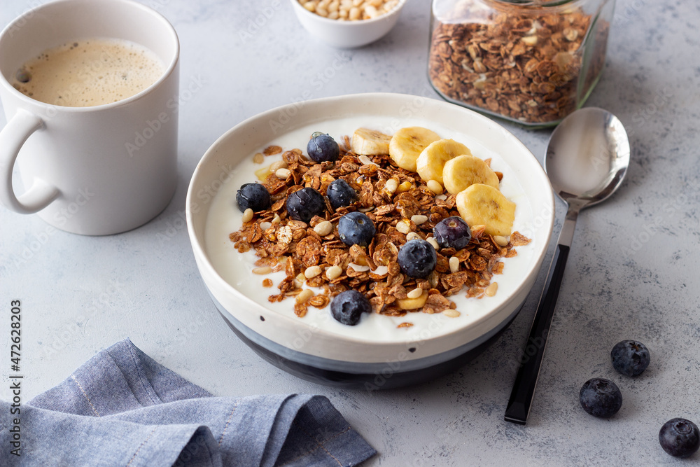 Granola with yogurt, blueberries, nuts, banana and honey. Muesli. Healthy eating. Vegetarian food. Granola with yogurt, blueberries, nuts, banana and honey. Muesli. Healthy eating. Vegetarian food.