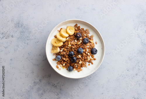 Granola with yogurt, blueberries, nuts, banana and honey. Muesli. Healthy eating. Vegetarian food.