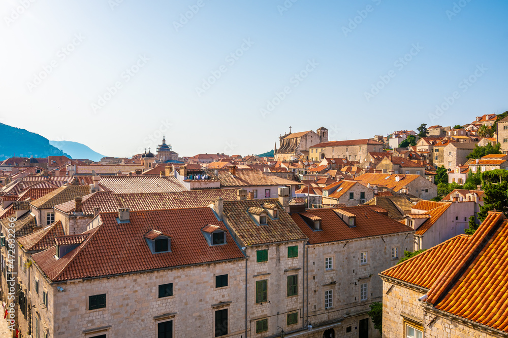 Aerial panoramic view of old city of Dubrovnik. Church tower and look to ancient buildings. Sunny day.