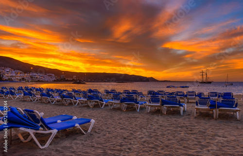 Beach Playa de Las Vistas with sun loungers at sunrise on Tenerife, Canary Islands, Spain © Ekaterina Belova