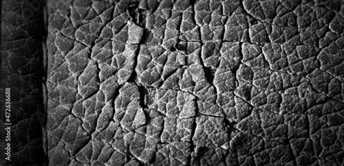 Focus stack macro of cracked faux leather on furniture with visible damage.