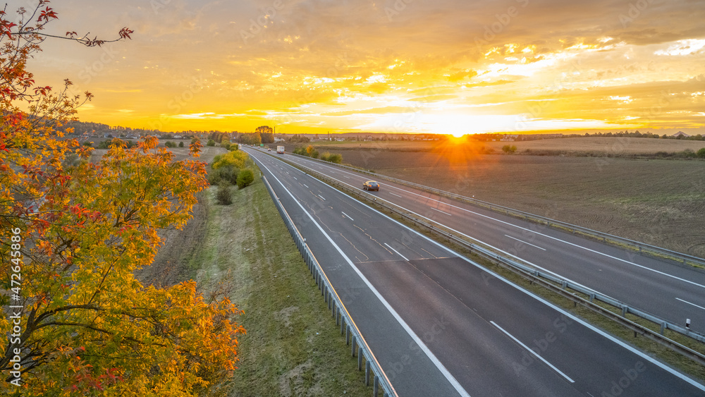 Highway at sunset in autumn evening