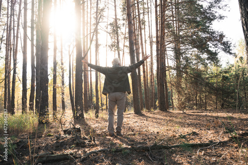 Overjoyed old man feeling freedom while traveling in forest during the autumn © Yakobchuk Olena