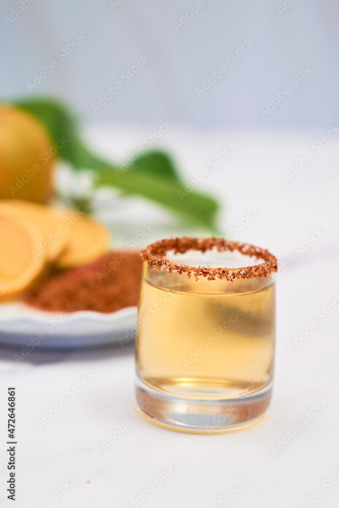 Mexican mezcal shot with chili pepper and orange. Mexican mezcal shot with chili pepper and orange.