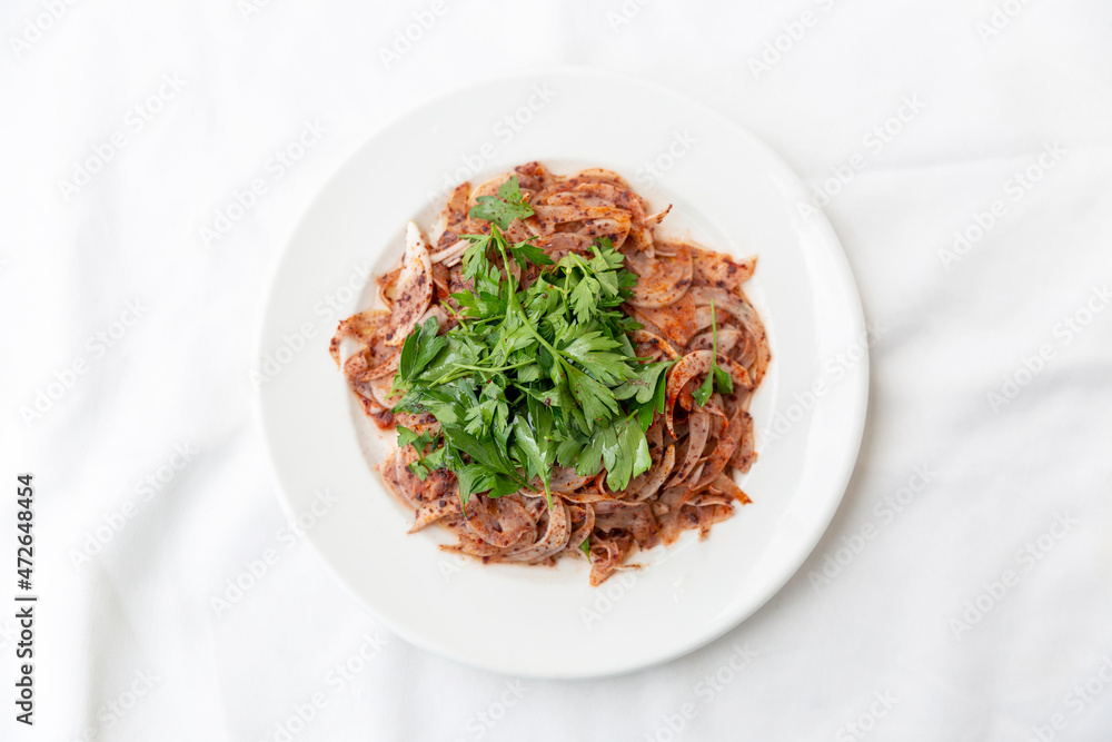 onion salad with parsley on white background onion salad with parsley on white background