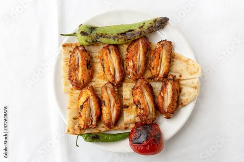 Chicken wings, chicken kebab with grilled vegetables
