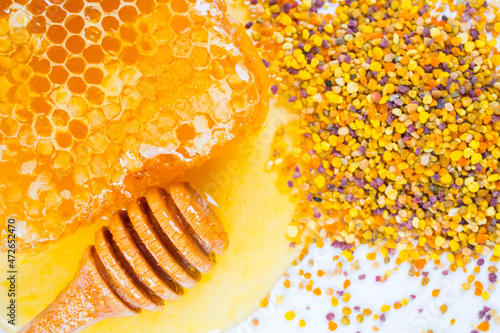Honey with dipper, honeycomb and bee pollen on white background. 