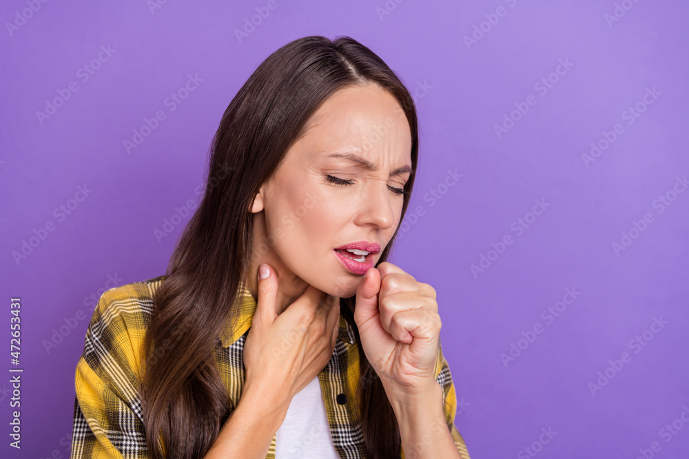 Photo of sick young brunette lady coughing wear checkered shirt isolated on purple color background Photo of sick young brunette lady coughing wear checkered shirt isolated on purple color background