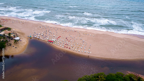 Aerial view of Imbassai beach, Bahia, Brazil. Beautiful beach in the northeast with a river and palm trees. photo