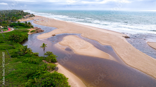 Aerial view of Imbassai beach, Bahia, Brazil. Beautiful beach in the northeast with a river and palm trees.