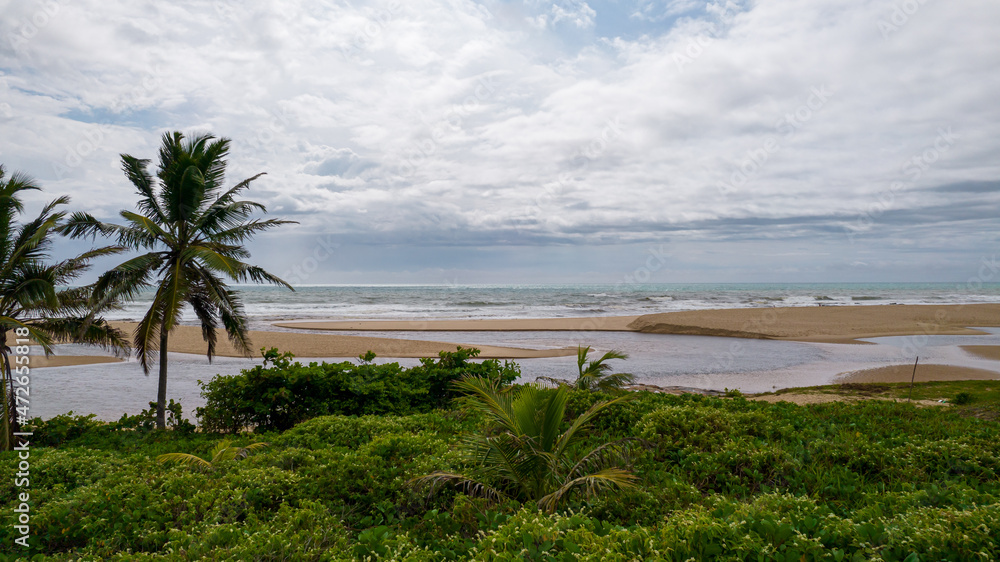 Aerial view of Imbassai beach, Bahia, Brazil. Beautiful beach in the northeast with a river and palm trees. Aerial view of Imbassai beach, Bahia, Brazil. Beautiful beach in the northeast with a river and palm trees.