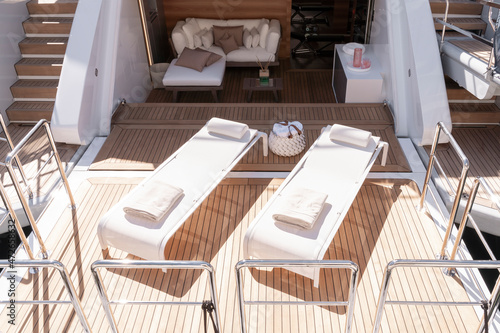 Aft deck with two sunbeds, couch, table on luxury yacht sun terrace Monaco yacht show © DiMar