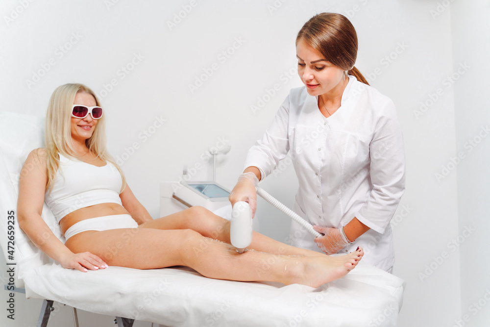 Obraz premium Laser epilation and cosmetology in beauty salon. Laser hair removal, skin care. Master do laser hair remove procedure.
