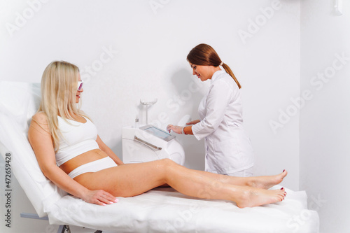Laser epilation and cosmetology in beauty salon. Laser hair removal, skin care. Master do laser hair remove prosedure.