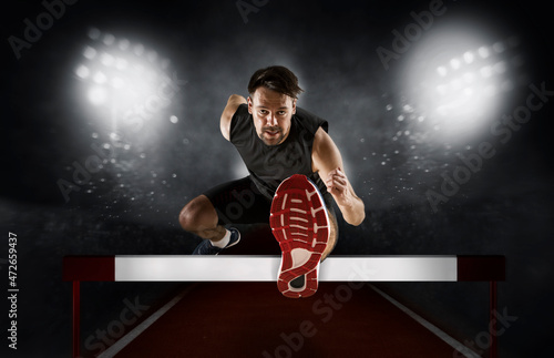 фотографія Man athlete hurdler running jumping over hurdles
