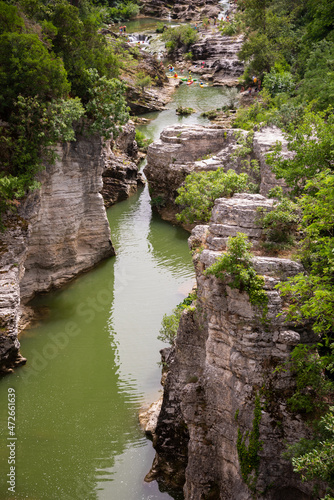 Winding river in a scenic canyon with rock and trees