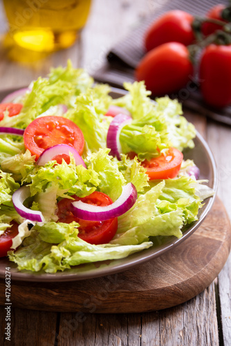 Green vegetable salad with lattuce, tomatos, onion. Healthy food concept