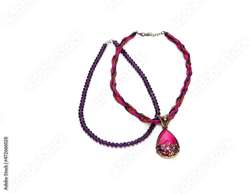 women's jewelry. bijouterie. red braided beads with a metal-rimmed stone. Two hair clips. on a white isolated background, top view