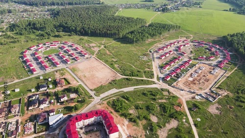 New modern townhouses in the suburbs, aerial view. Chalet complex on the outskirts of the city. Business concept, construction, environmentally friendly housing. UHD 4K. photo