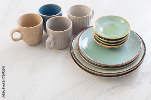 ceramic cups and plates on white marble table