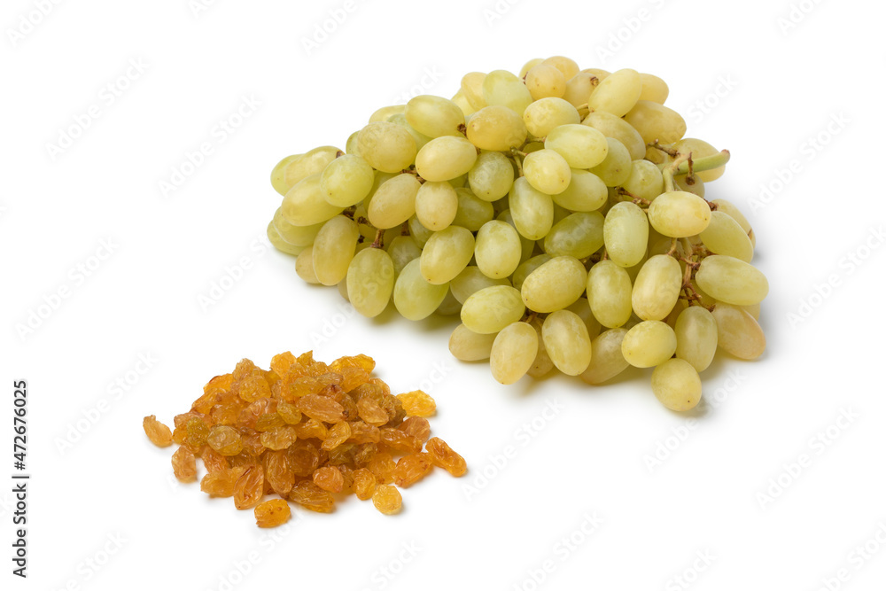 Bunch of fresh ripe Sultana grapes and dried raisins isolated on white background