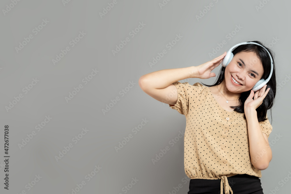 Cheerful woman posing wearing white wireless headphones Cheerful woman posing wearing white wireless headphones