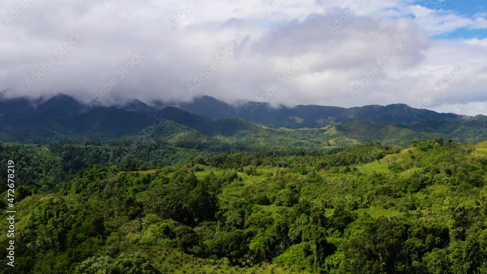 Mountain peaks are covered with rainforest and clouds. Jungle in the highlands on Luzon Island, Philippines. rainforest on the top of a mountain covered with fog in the morning. Rain clouds in a Mountain peaks are covered with rainforest and clouds. Jungle in the highlands on Luzon Island, Philippines. rainforest on the top of a mountain covered with fog in the morning. Rain clouds in a