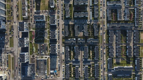 Modern residential disctrict in Europe city from above. Block flats and cottages. Streets, cars, yards. New town. High shot. Looks like computer board. photo