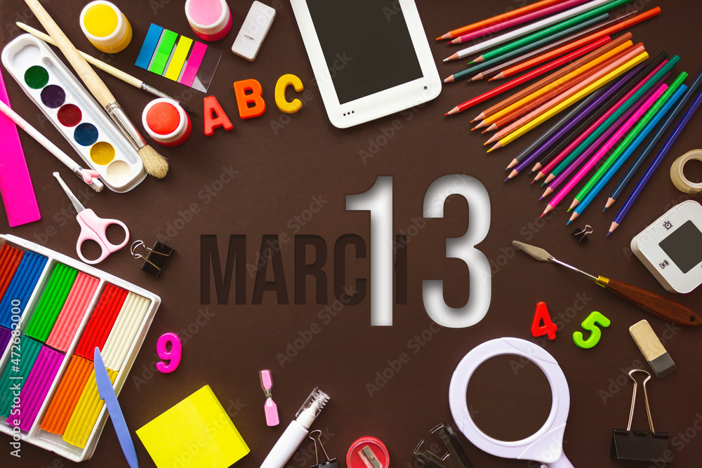 March 13rd. Day 13 of month, Calendar date. School notebook and various stationery with calendar day. School and office supplies frame. Spring month, day of the year concept. March 13rd. Day 13 of month, Calendar date. School notebook and various stationery with calendar day. School and office supplies frame. Spring month, day of the year concept.