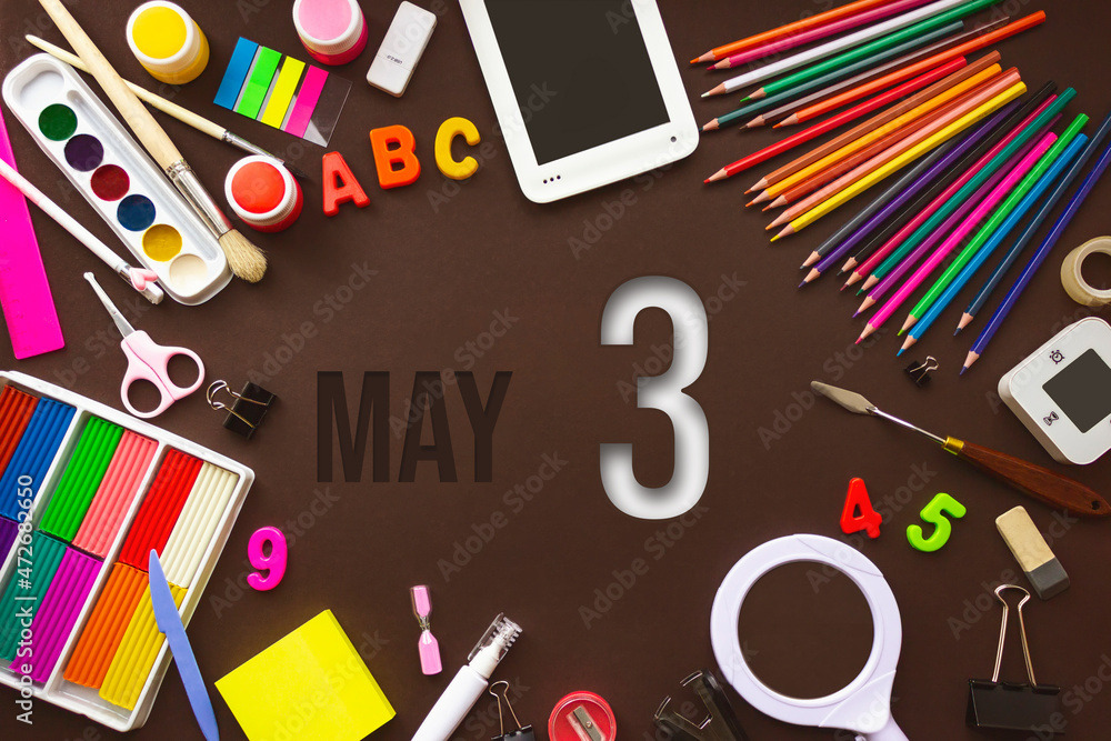 May 3rd. Day 3 of month, Calendar date. School notebook and various stationery with calendar day. School and office supplies frame. Spring month, day of the year concept. May 3rd. Day 3 of month, Calendar date. School notebook and various stationery with calendar day. School and office supplies frame. Spring month, day of the year concept.
