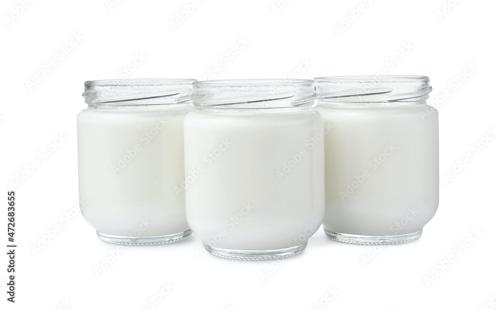 Glass jars with delicious homemade yogurt on white background Glass jars with delicious homemade yogurt on white background