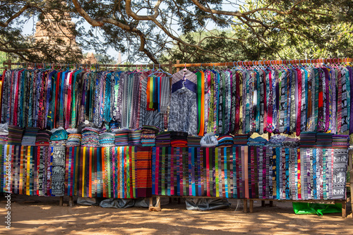 Handmade colorful Burmese fabric for sell in a tourist stall on the street market near Inle Lake in Burma, Myanmar © OlegD