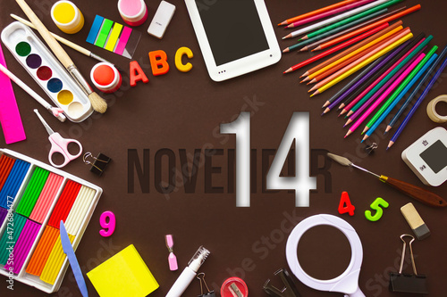November 14th. Day 14 of month  Calendar date. School notebook and various stationery with calendar day. School and office supplies frame. Autumn month  day of the year concept.