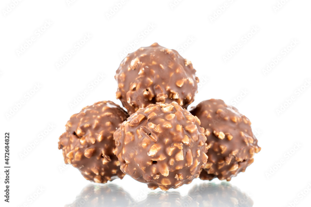 Several sweet chocolate candies with nuts, close-up, isolated on white. Several sweet chocolate candies with nuts, close-up, isolated on white.