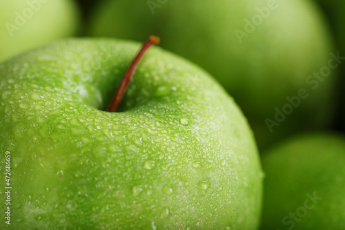 Background of ripe and juicy green apples, perspective from above.