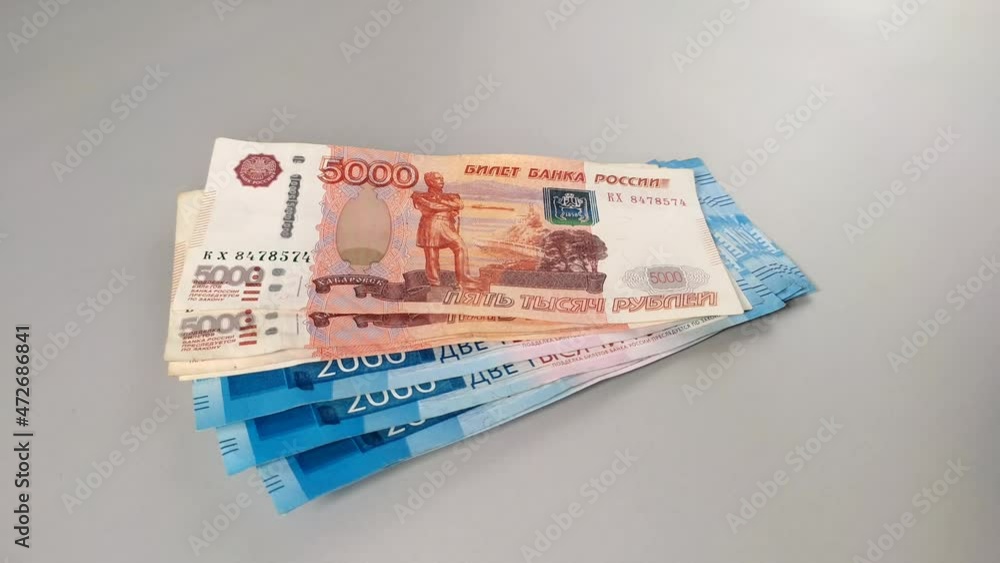 Russian money five-thousand-dollar bills throw on the table with a fan Russian money five-thousand-dollar bills throw on the table with a fan