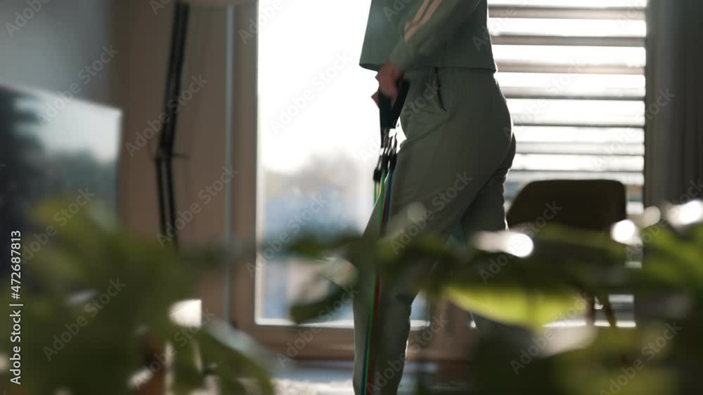 Woman doing exercises with resistance bands at home. Woman doing exercises with resistance bands at home.
