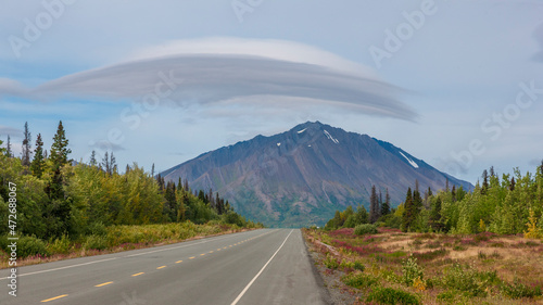 Canada, Yukon. Lenticular cloud over mountain on the Haines Highway.