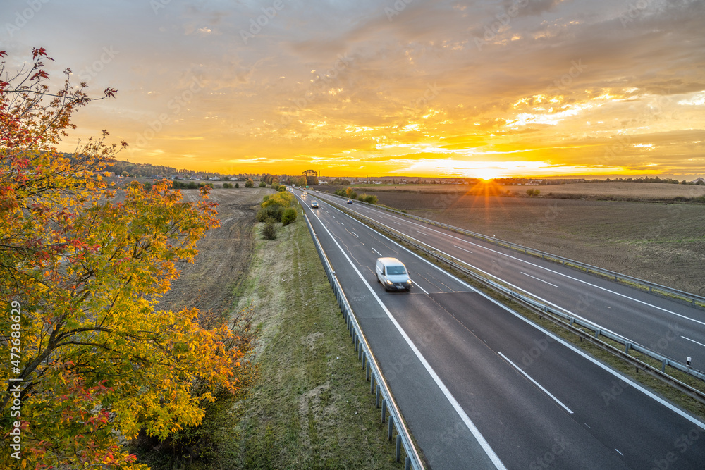 Highway at sunset in autumn evening