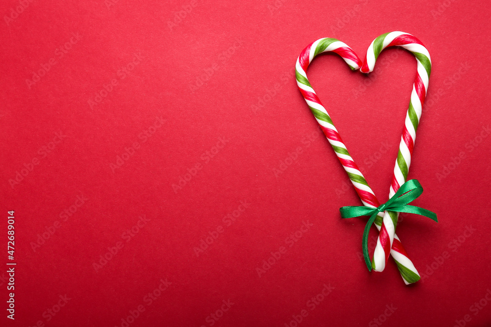 Candy canes on a red background. Flat lay, top view. Candy canes on a red background. Flat lay, top view.