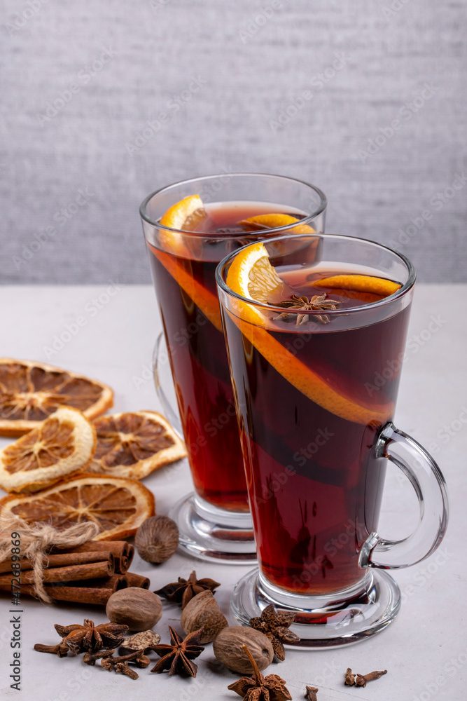 Mulled wine in a glass glass on a gray concrete background