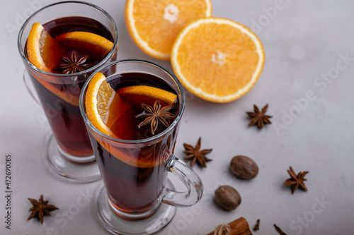 Mulled wine in a glass glass on a gray concrete background
