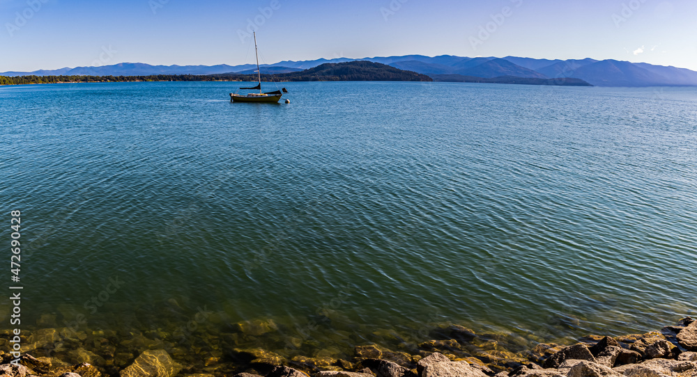 Yellow Sailboat on Lake Pend d' Oreille With Mountains From Pend d’ Oreille Bay Trail , Sandpoint, Idaho, USA