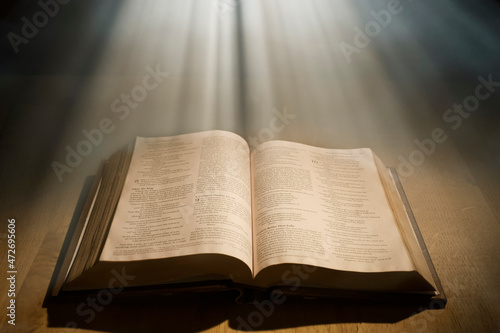 Godly light rays shining on a Open bible