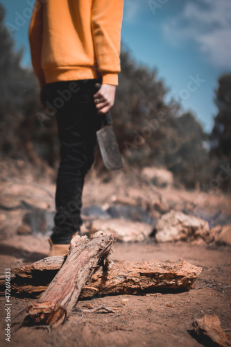 the person cutting the woods in the forest