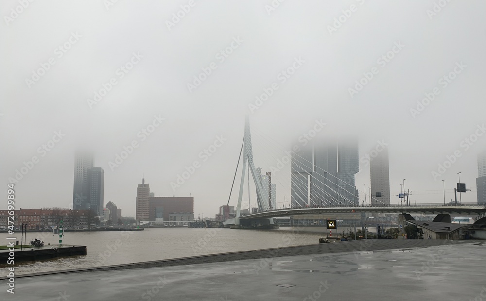 Skyline of Rotterdam with heavy rain clouds and mist Skyline of Rotterdam with heavy rain clouds and mist