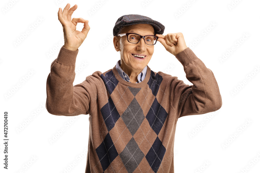 Smiling elderly man holding his glasses and gesturing ok sign Smiling elderly man holding his glasses and gesturing ok sign